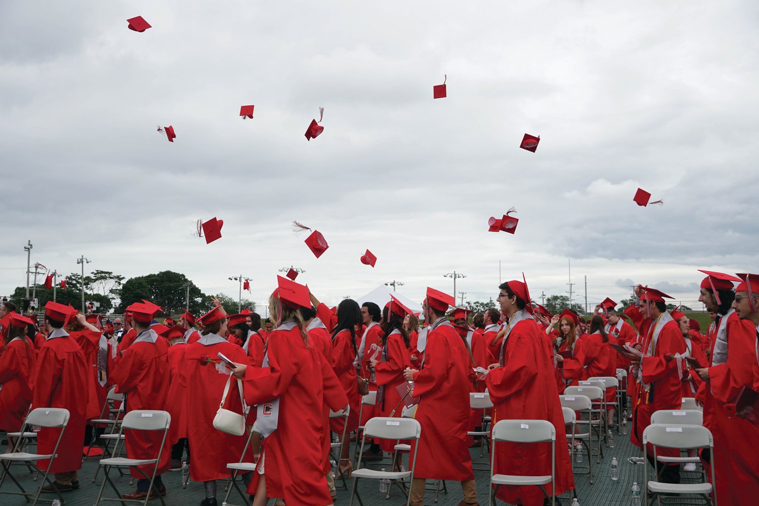 LOOKING UP: The members of the Cranston West class of 2021 throw up their caps in celebration at the end of Saturday’s
graduation ceremony at Cranston Stadium. (Herald photos by Stephanie Bernaba)